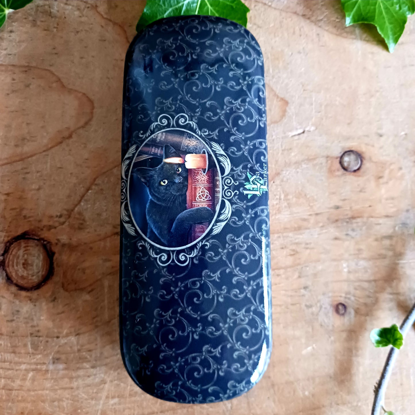 Protect your eyewear in spellbinding style with the Witching Hour Glasses Case by renowned fantasy artist Lisa Parker. Featuring the captivating Witching Hour artwork, this enchanting case is brought to life with vibrant, high-quality printing that truly stands out.