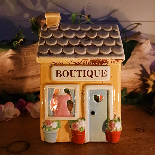 Bring a little village charm into your home with this delightful Village Pottery Boutique Tealight Holder. Hand-crafted in ceramic and beautifully hand-painted, this charming miniature shop makes a lovely decorative feature both with or without a candle.