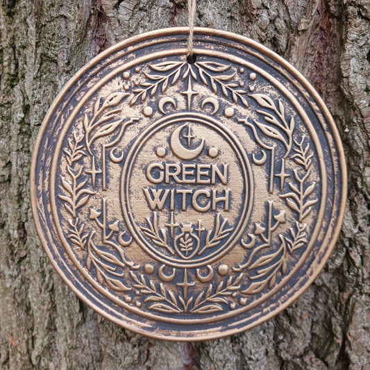 The Green Witch Bronze Effect Terracotta Hanging Plaque infuses your space with grounded, earthy energy and ancient symbolism.