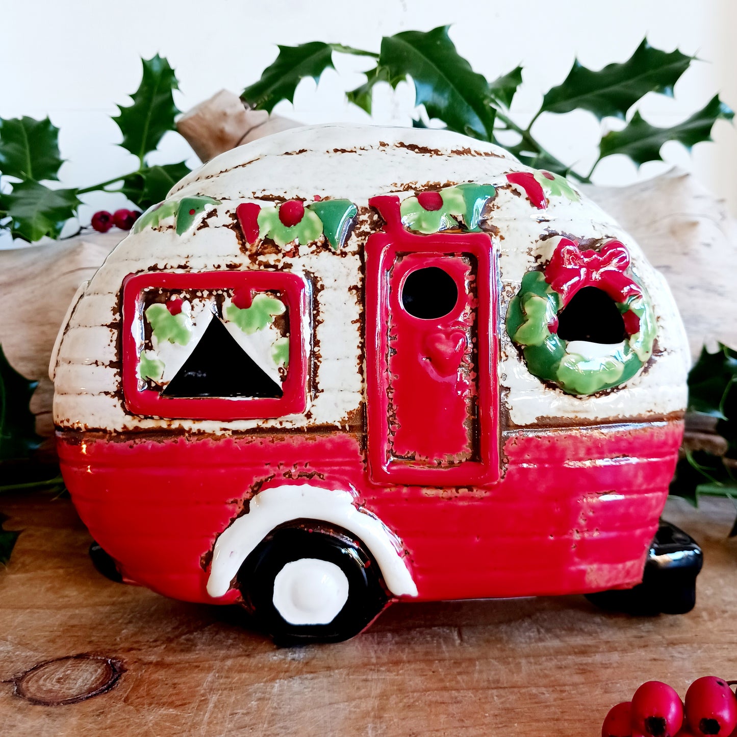 Step into a cosy winter wonderland with the Village Pottery Christmas Caravan Tealight Holder, a heart-warming piece crafted with love and festive magic. Measuring 13.5 x 18.5 x 7 cm, this hand-painted ceramic caravan glows with Christmas cheer, ready to light up your home with a gentle, enchanting flicker.