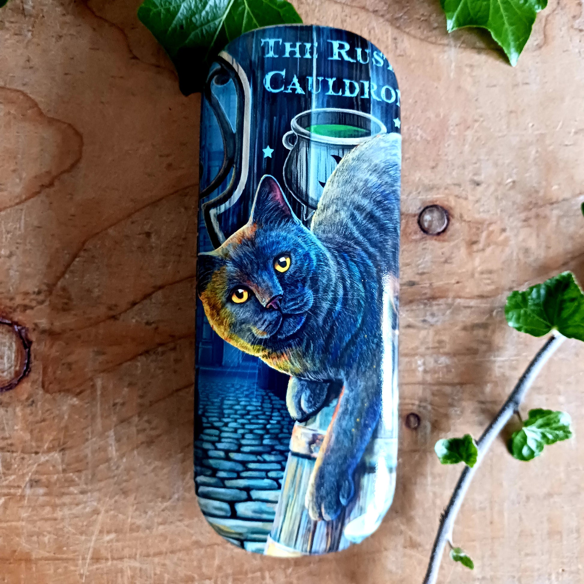 Protect your spectacles in enchanting style with this hard shell glasses case featuring Lisa Parker’s ‘Rusty Cauldron’ artwork. Designed to guard your eyewear from scratches, pressure, and everyday wear, this sturdy case is perfect for handbags, backpacks, or bedside storage.