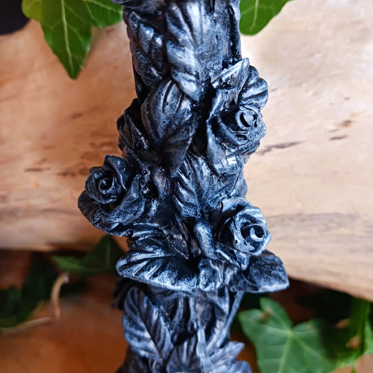 Add a touch of dark elegance to your home with the Midnight Rose Gothic Candlestick Holder. Beautifully crafted with a stone pillar design, this striking ornament features intricate black roses and dark vegetation, creating a mysterious gothic aesthetic that makes a statement in any room.