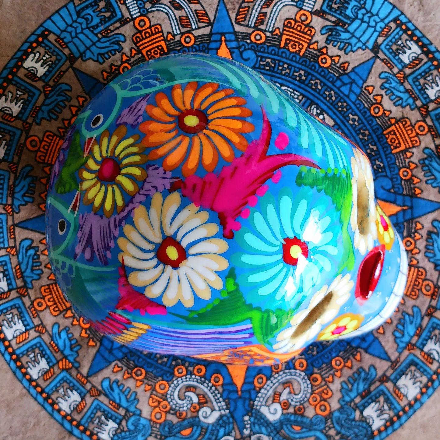 These fun ceramic sugar skull ornaments have been beautifully painted in bright colours and finished with a high shine glaze. They are a popular item during Día de Los Muertos or Day of the Dead festivities, held in Mexico every November to celebrate welcoming the souls of their deceased relatives back for a time of food, drink and celebration.