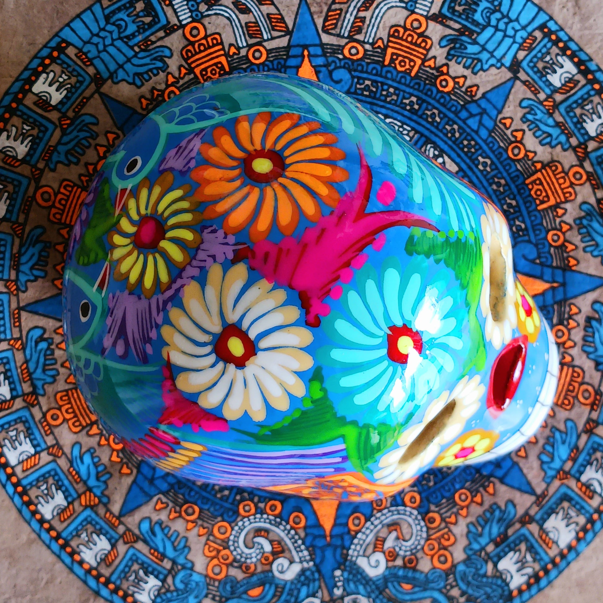 These fun ceramic sugar skull ornaments have been beautifully painted in bright colours and finished with a high shine glaze. They are a popular item during Día de Los Muertos or Day of the Dead festivities, held in Mexico every November to celebrate welcoming the souls of their deceased relatives back for a time of food, drink and celebration.