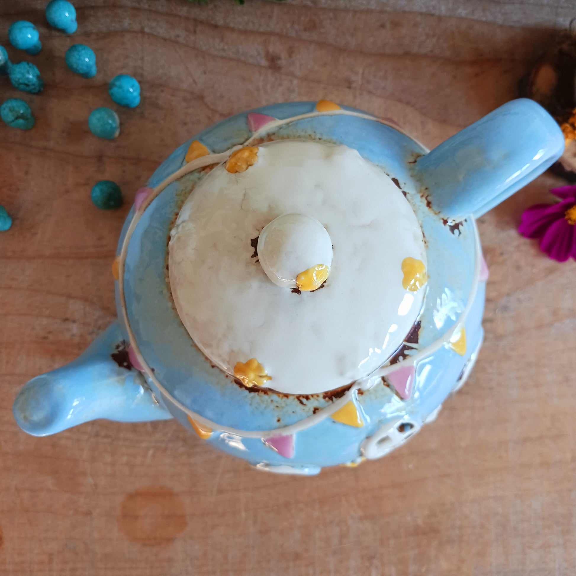 Create a warm and cosy atmosphere in your home with this charming Round Teapot Tealight Holder from the Village Pottery Collection. Crafted in a unique teapot shape, this ceramic tealight holder makes a delightful decorative piece for shelves, windowsills, or side tables. Simply place a tealight inside to enjoy a soft, glowing ambience.