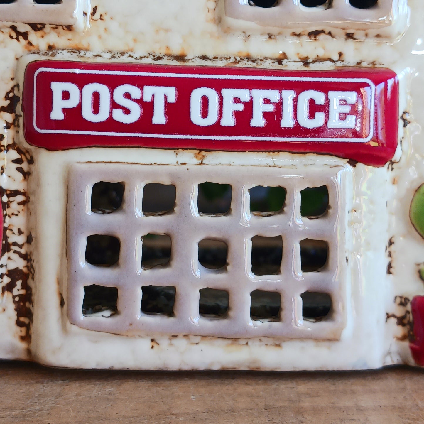 Whispers travel by candlelight from this Village Pottery Post Office tealight house, where tiny windows glow like messages carried between realms. Crafted from ceramic and measuring 12x15x7cm, this enchanting piece brings warmth and quiet magic to your sacred space.