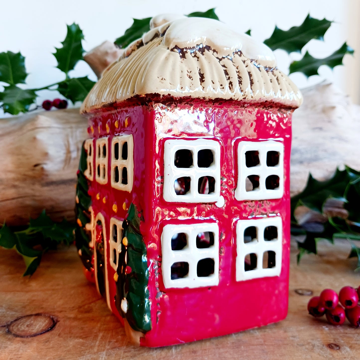 Bring timeless festive charm into your home with the Village Pottery Christmas Thatched Roof House Tealight Holder, a handcrafted ceramic cottage glowing with the spirit of the season. Measuring 17 x 12.5 x 8.5 cm, this enchanting piece captures the essence of a peaceful winter’s night — where golden candlelight flickers through snowy windows beneath a soft thatched roof.