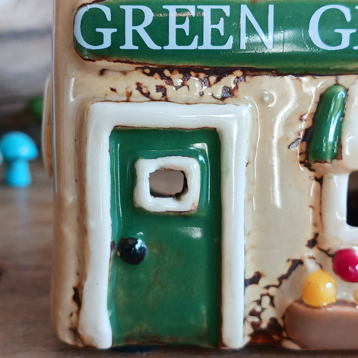 Illuminate your home with the charming Village Pottery Green Grocers Shop Tealight Holder. Handcrafted with a rustic green finish, this cosy piece adds warmth and ambience to any room. Perfect for tealights or simply as a decorative ornament, it’s a delightful addition to shelves, windowsills, or coffee tables. Pair with other pieces from the Village Pottery Collection to create your own quaint, decorative village.