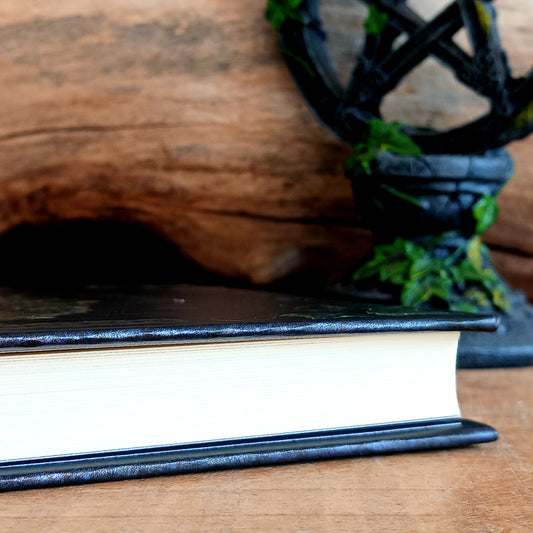 Unlock your inner mystic with this beautifully crafted Embossed Book of Shadows A5 Notebook, designed for those who walk the path of magic, mystery, and self-expression.