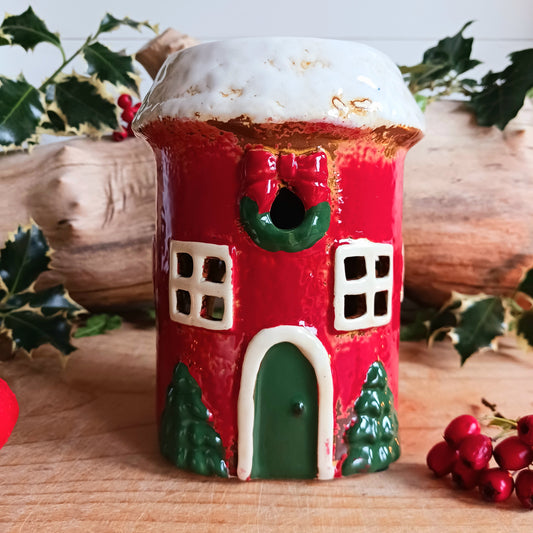 Bring timeless holiday charm to your home with this Handcrafted Christmas Oil Wax Warmer by Village Pottery. Designed in the shape of a festive wreath, this ceramic warmer combines beauty and practicality for the holiday season. Perfect for wax melts or essential oils, it creates a warm and inviting atmosphere as the fragrance fills your space.