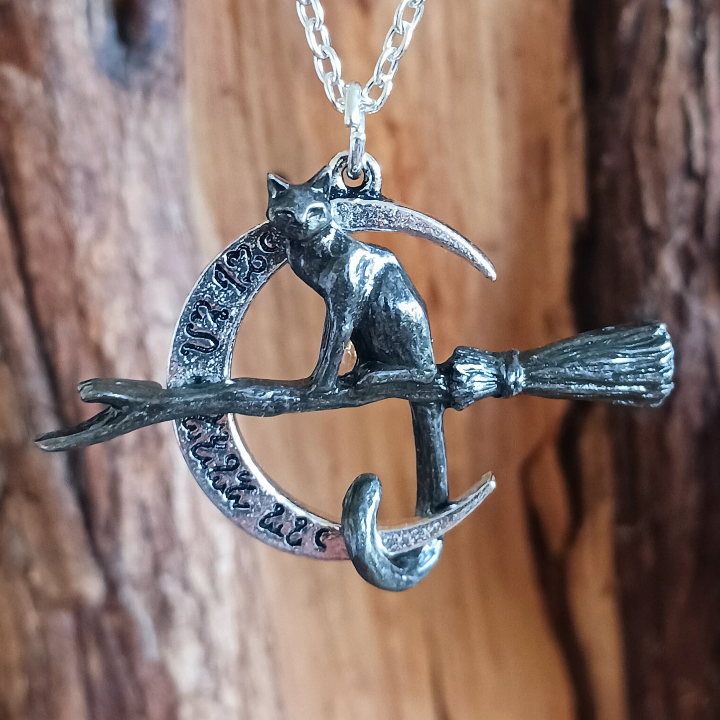 Embrace the magic of the Samhain Sabbat with the Regina Covenorum Necklace. Handcrafted from fine English pewter, this enchanting pendant features a black cat riding a witches’ broom, framed by a polished crescent moon engraved with arcane Theban symbols. Perfect for lovers of mystical jewellery, witchcraft, and celestial-inspired designs, this necklace celebrates the mysterious bond between a witch and her familiar. 