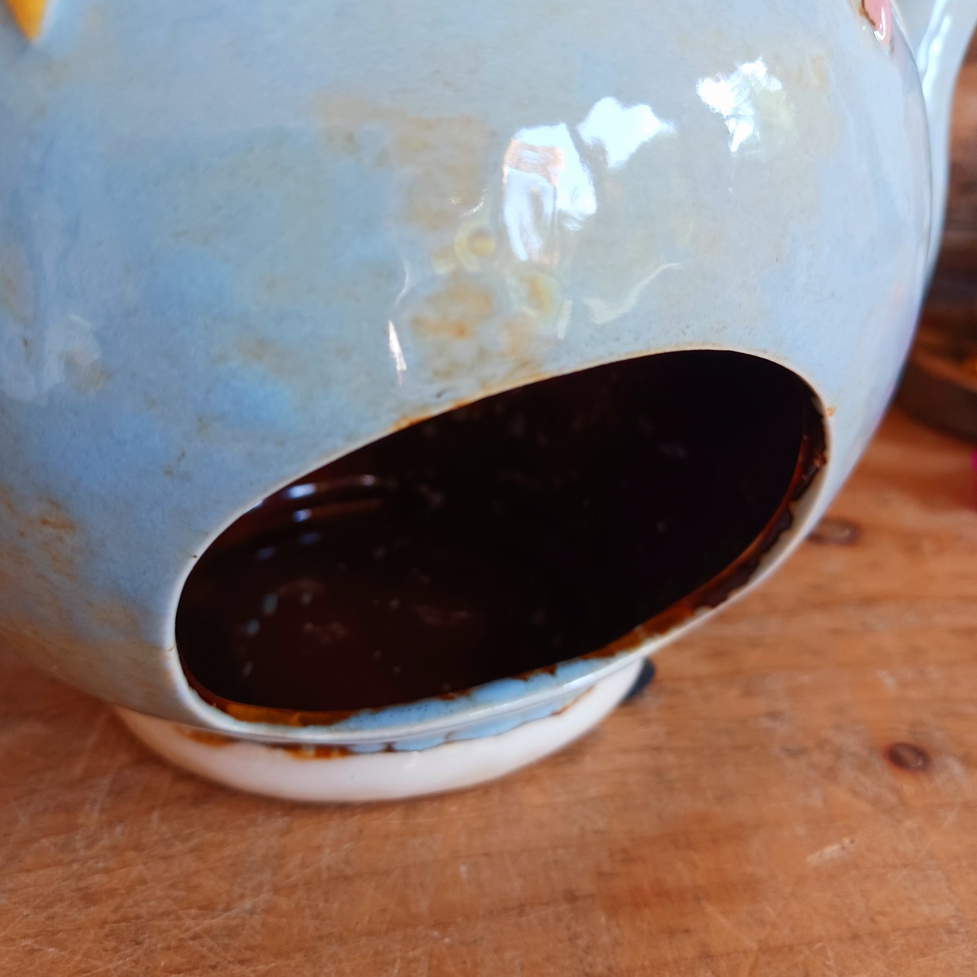 Create a warm and cosy atmosphere in your home with this charming Round Teapot Tealight Holder from the Village Pottery Collection. Crafted in a unique teapot shape, this ceramic tealight holder makes a delightful decorative piece for shelves, windowsills, or side tables. Simply place a tealight inside to enjoy a soft, glowing ambience.