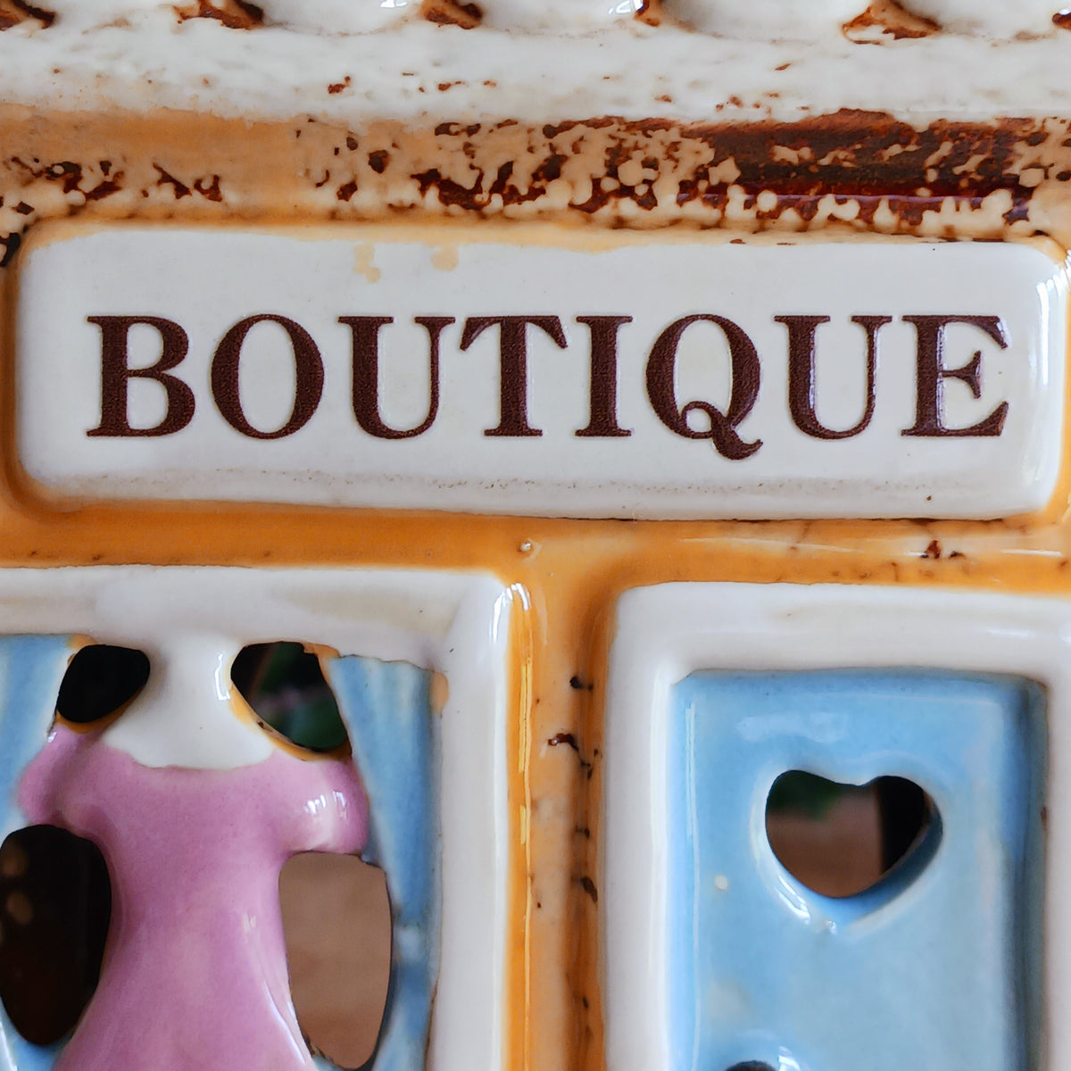 Bring a little village charm into your home with this delightful Village Pottery Boutique Tealight Holder. Hand-crafted in ceramic and beautifully hand-painted, this charming miniature shop makes a lovely decorative feature both with or without a candle.