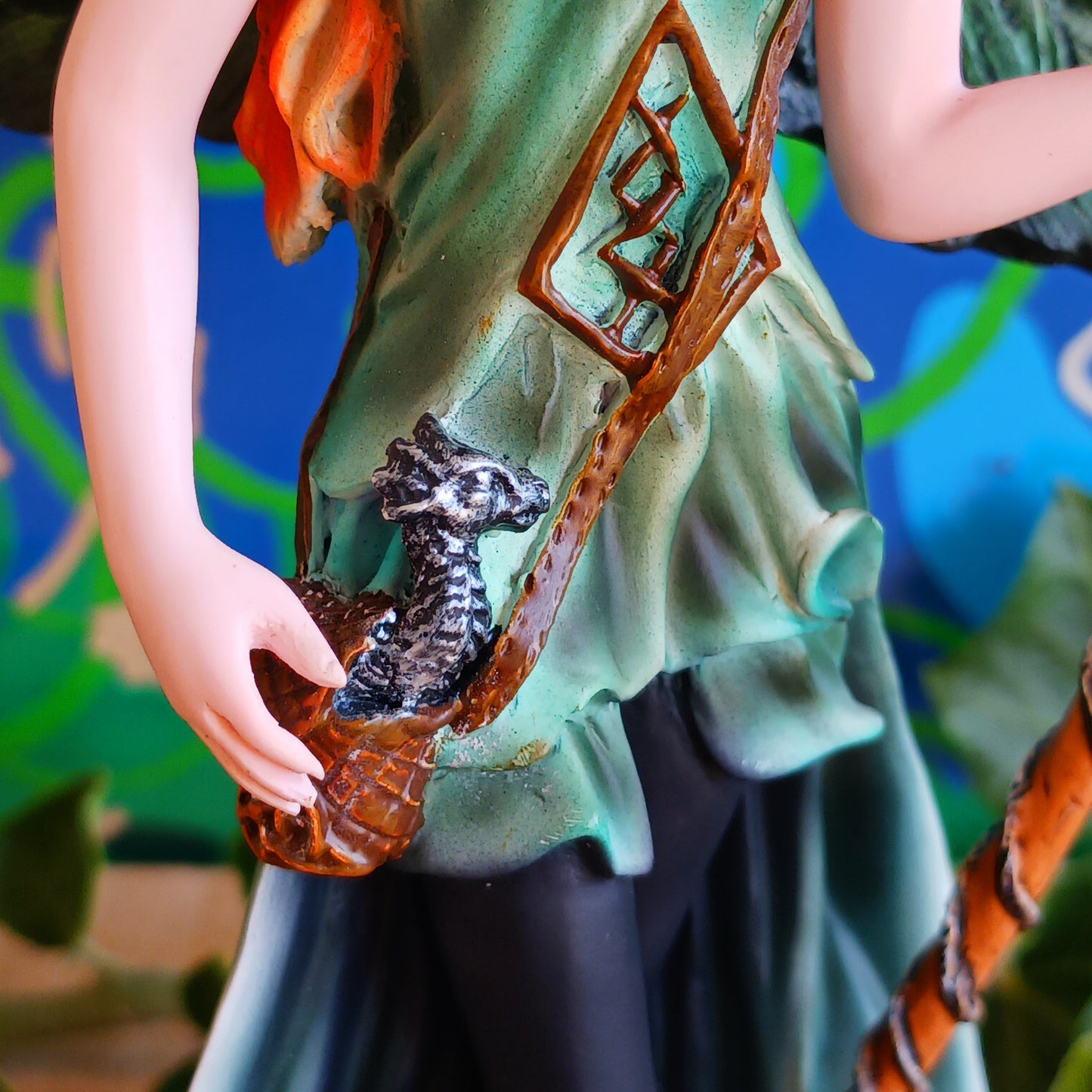 Meet Forest Fae, the whimsical guardian of the woods. This stunning standing fairy figurine captures the perfect blend of natural beauty and kawaii charm. Hand-painted with exquisite detail, she wears a lush forest green outfit, accented by leaf-shaped brooches, and holds a mystical staff crowned with a purple jewel. 