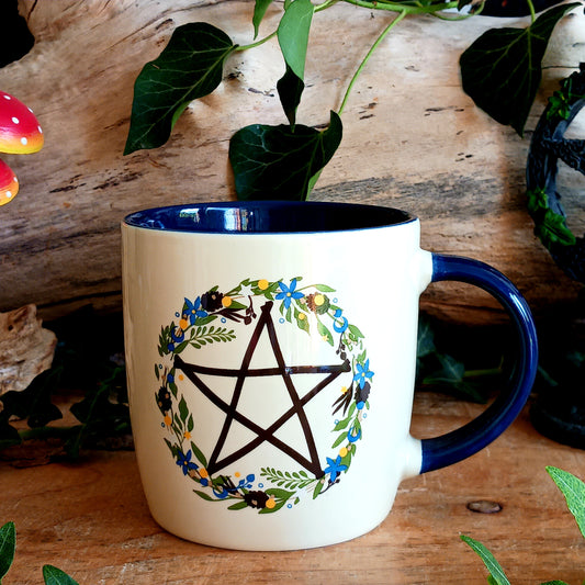 Celebrate the magic of the seasons with this Solstice Wreath Botanical Pentagram Mug, designed for those who love mystical décor, nature-inspired artwork and cosy rituals. Featuring a beautiful botanical pentagram wreath, this enchanting mug is perfect for sipping warming coffees, herbal teas or rich hot chocolates throughout the colder months.