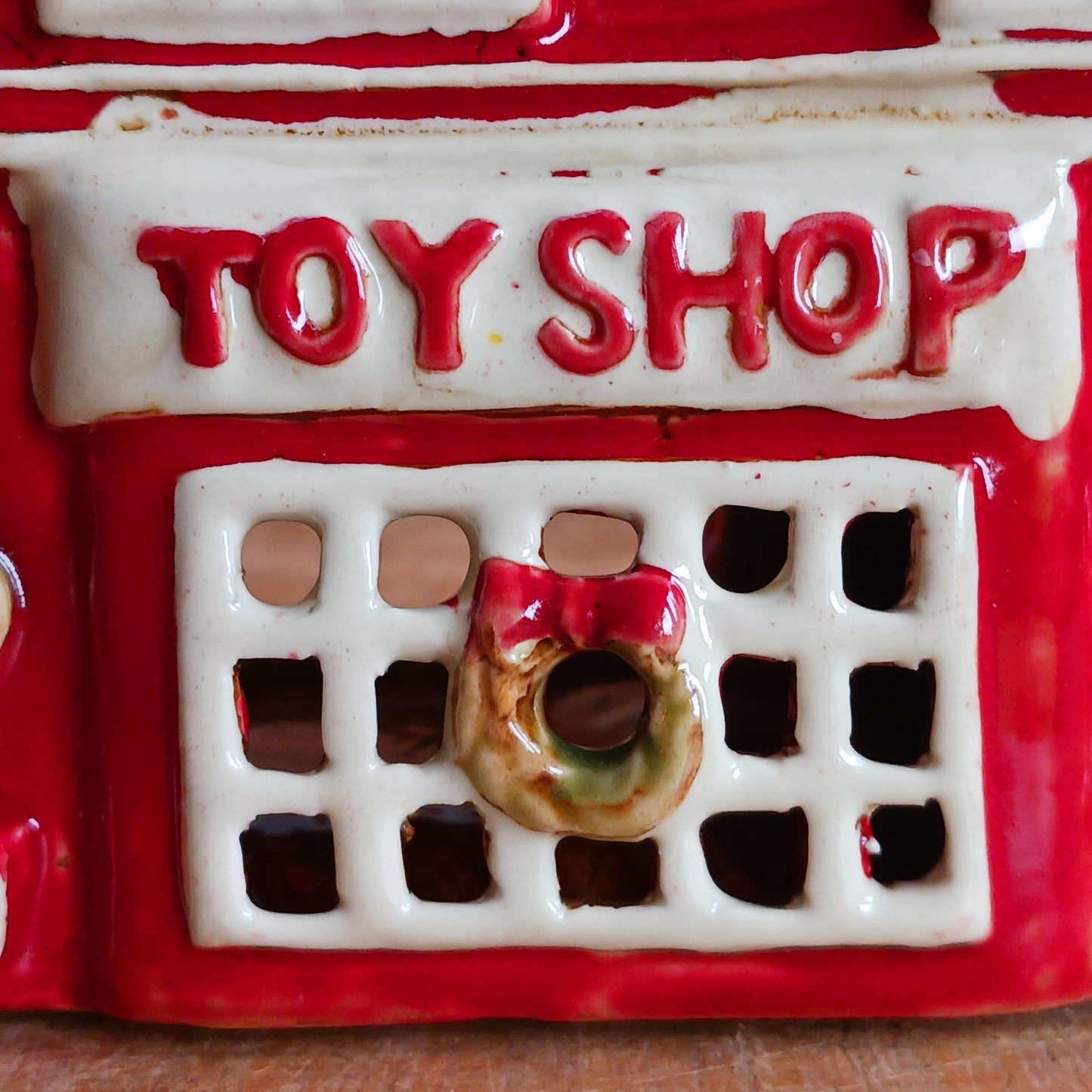 Bring nostalgic festive charm to your home with our Christmas Toy Shop Ceramic Tealight Holder, handcrafted in the Village Pottery workshop. This detailed tealight house captures the magic of an old-world toy shop on a snowy winter’s evening. 