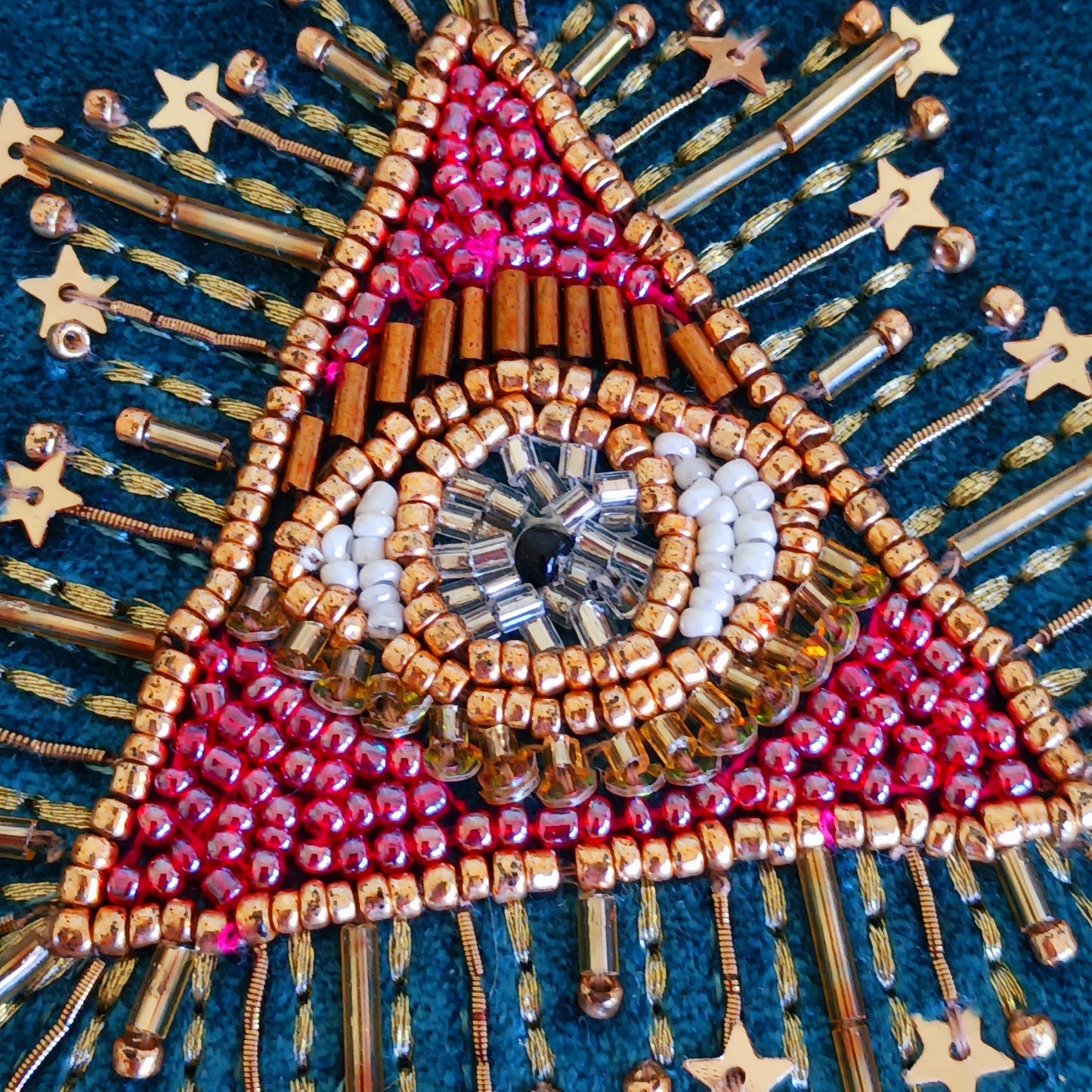 Add elegance and mystique to your collection with this finely embroidered jewellery and tarot box. Made in India and crafted from soft velvet in a rich blue hue, this piece is adorned with intricate embroidery and ornamental beads for a touch of luxury. Perfect for storing jewellery, tarot cards, crystals, or other cherished items, its small strap and button closure keep your treasures secure.