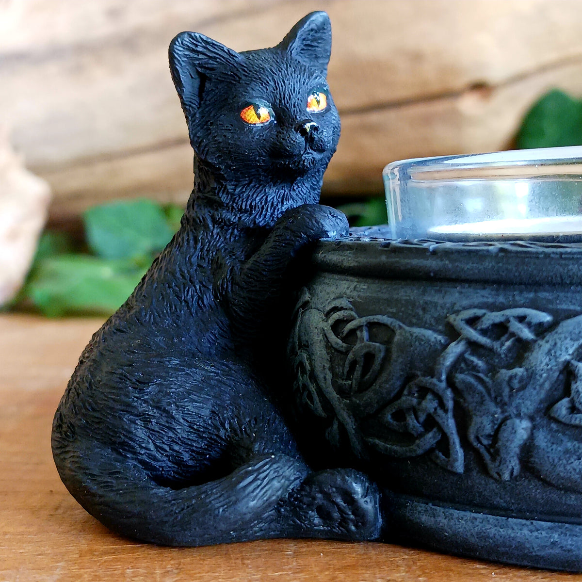 Bring a touch of playful witchcraft and gothic charm into your home with the Familiar Trio Tea Light Holder. Featuring three mischievous black cat familiars gathered around a central tealight, this enchanting candle holder creates a warm and atmospheric glow with plenty of magical character.