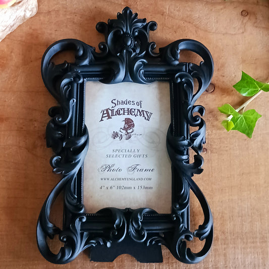 Add a touch of dark elegance to your home with this ornate Black Rococo Photo Frame. Inspired by the opulence of a bygone era, this decorative resin frame features elaborate scrollwork, flowing curves and a dramatic black finish, creating a striking statement piece for gothic, vintage and alternative interiors.