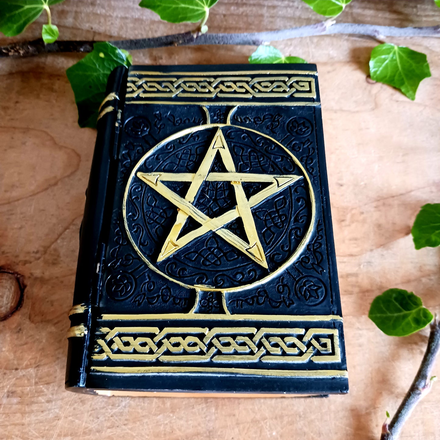 Evoke the power of the old ways with this enchanting Spell Box Grimoire Storage Box from Nemesis Now. Designed to resemble an ancient spell book, this beautifully decorated grimoire opens to reveal a hidden storage compartment—perfect for keeping your magical tools, crystals, herbs, spell ingredients, or keepsakes safely stored.