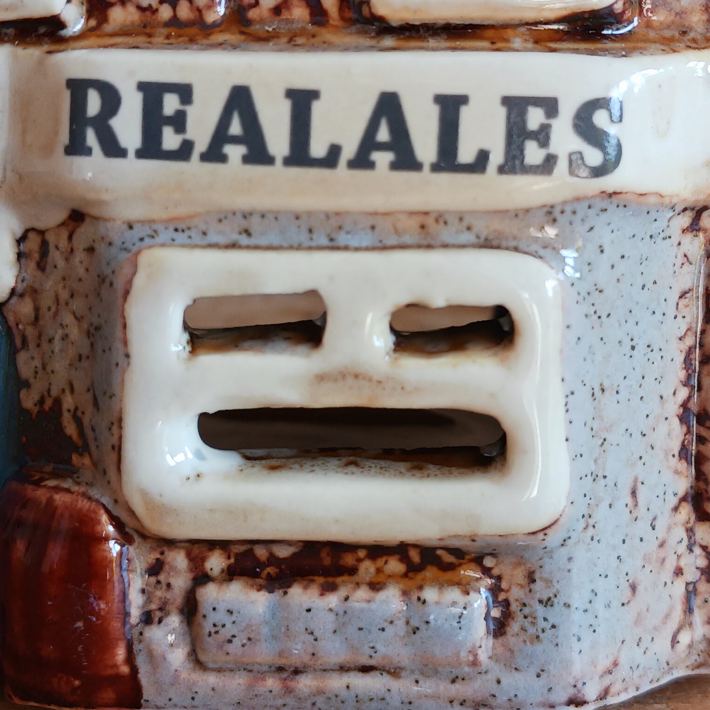 Bring the warmth of a cozy pub into your home with the Village Pottery Crown Pub Tealight. Crafted from ceramic with intricate detailing, this charming piece features a rear cut-out for easy placement of a tealight or string lights. Watch as the soft glow spills through the windows, creating a welcoming pub atmosphere. Perfect for building your own enchanting village display, this timeless decoration adds warmth and character to any space.