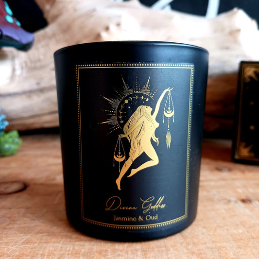 This lustrous manifestation candle in a coloured glass container, has been hand poured from toxin-free soy and blended with Jasmine and Oud essential oils and gemstones.