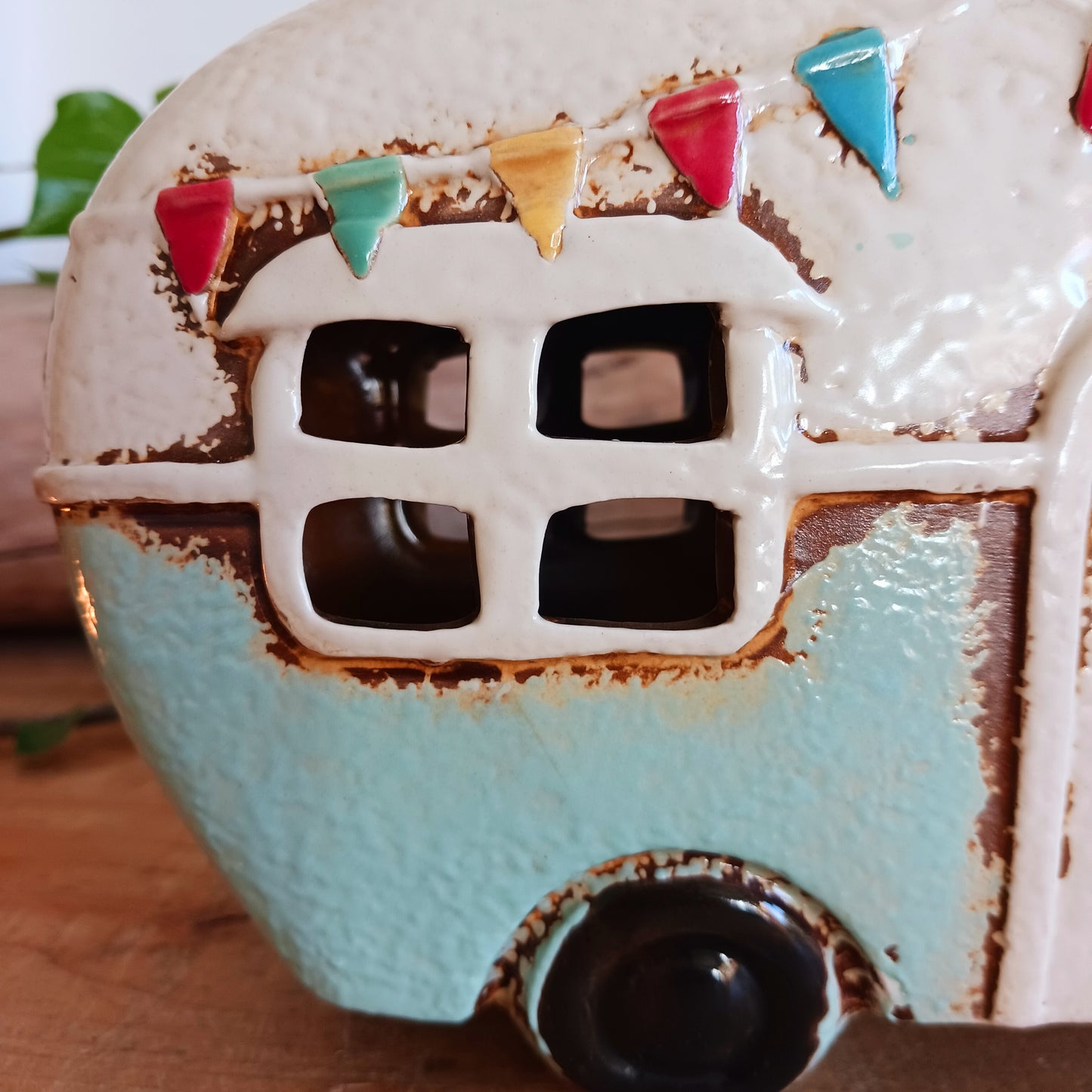 From the enchanted lanes of Village Pottery comes this Aqua Caravan Money Box, a charming ceramic treasure crafted for dreamers and wanderers alike. Measuring 13.5 x 18.5 x 6.5 cm, this delightful piece captures the spirit of adventure with its soft aqua glaze, vintage caravan design, and hand-painted detailing that feels kissed by fairy dust.