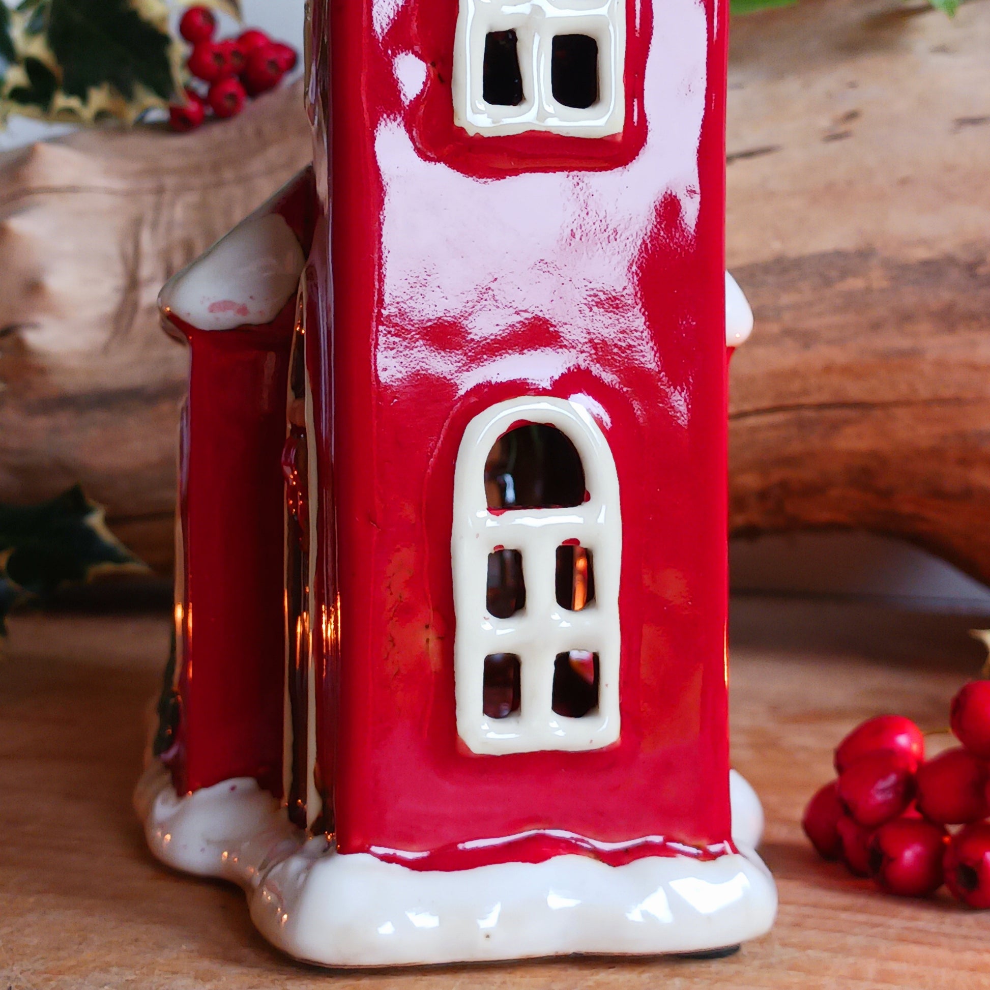 Bring festive warmth to your home with the Large Christmas Church Tealight Holder from the Village Pottery collection. This beautifully handcrafted ceramic piece features rustic detailing, evoking the charm of a snow-covered church glowing softly with candlelight.