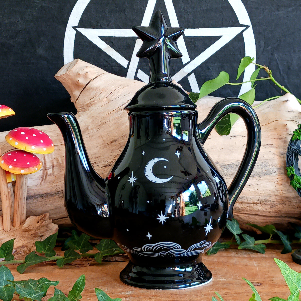 Add a touch of celestial magic to tea time with this striking black ceramic teapot, beautifully decorated with moon and star details and finished with a statement star-shaped lid.