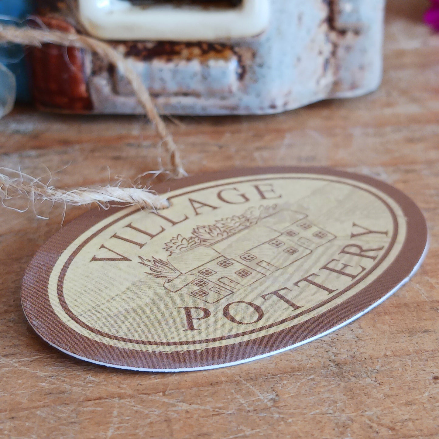 Bring the warmth of a cozy pub into your home with the Village Pottery Crown Pub Tealight. Crafted from ceramic with intricate detailing, this charming piece features a rear cut-out for easy placement of a tealight or string lights. Watch as the soft glow spills through the windows, creating a welcoming pub atmosphere. Perfect for building your own enchanting village display, this timeless decoration adds warmth and character to any space.