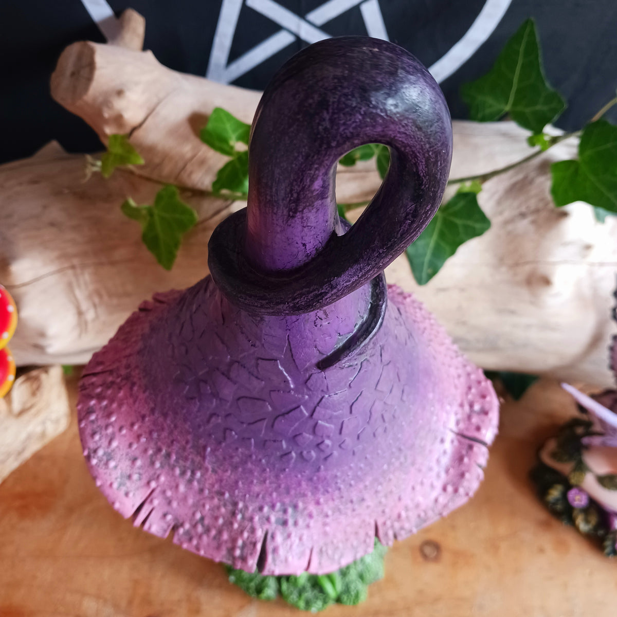 Bring a touch of magic and whimsical charm to your home with Twizzle Tumblethorne, a wonderfully quirky purple mushroom sculpture perfect for lovers of fantasy, fairies and nature-inspired decor.