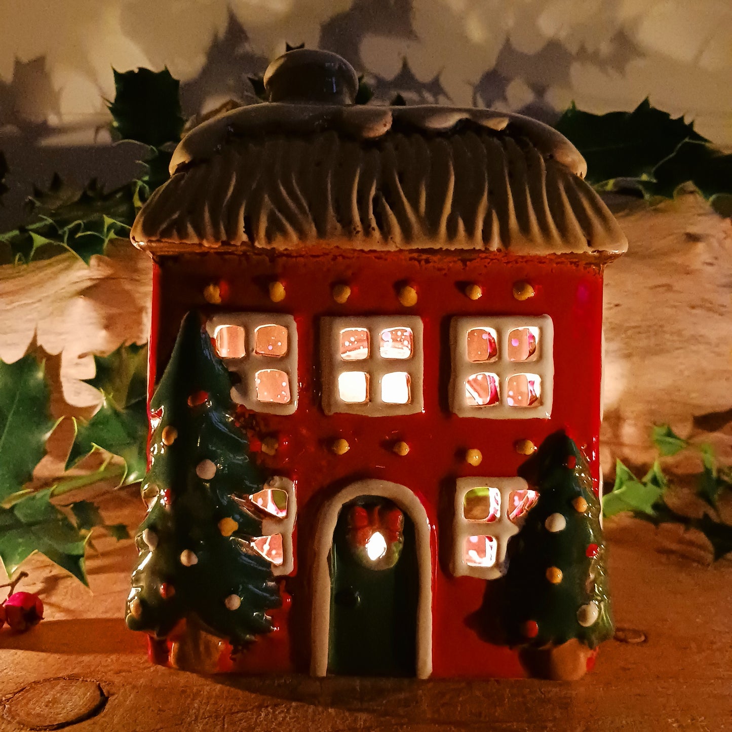 Bring timeless festive charm into your home with the Village Pottery Christmas Thatched Roof House Tealight Holder, a handcrafted ceramic cottage glowing with the spirit of the season. Measuring 17 x 12.5 x 8.5 cm, this enchanting piece captures the essence of a peaceful winter’s night — where golden candlelight flickers through snowy windows beneath a soft thatched roof.