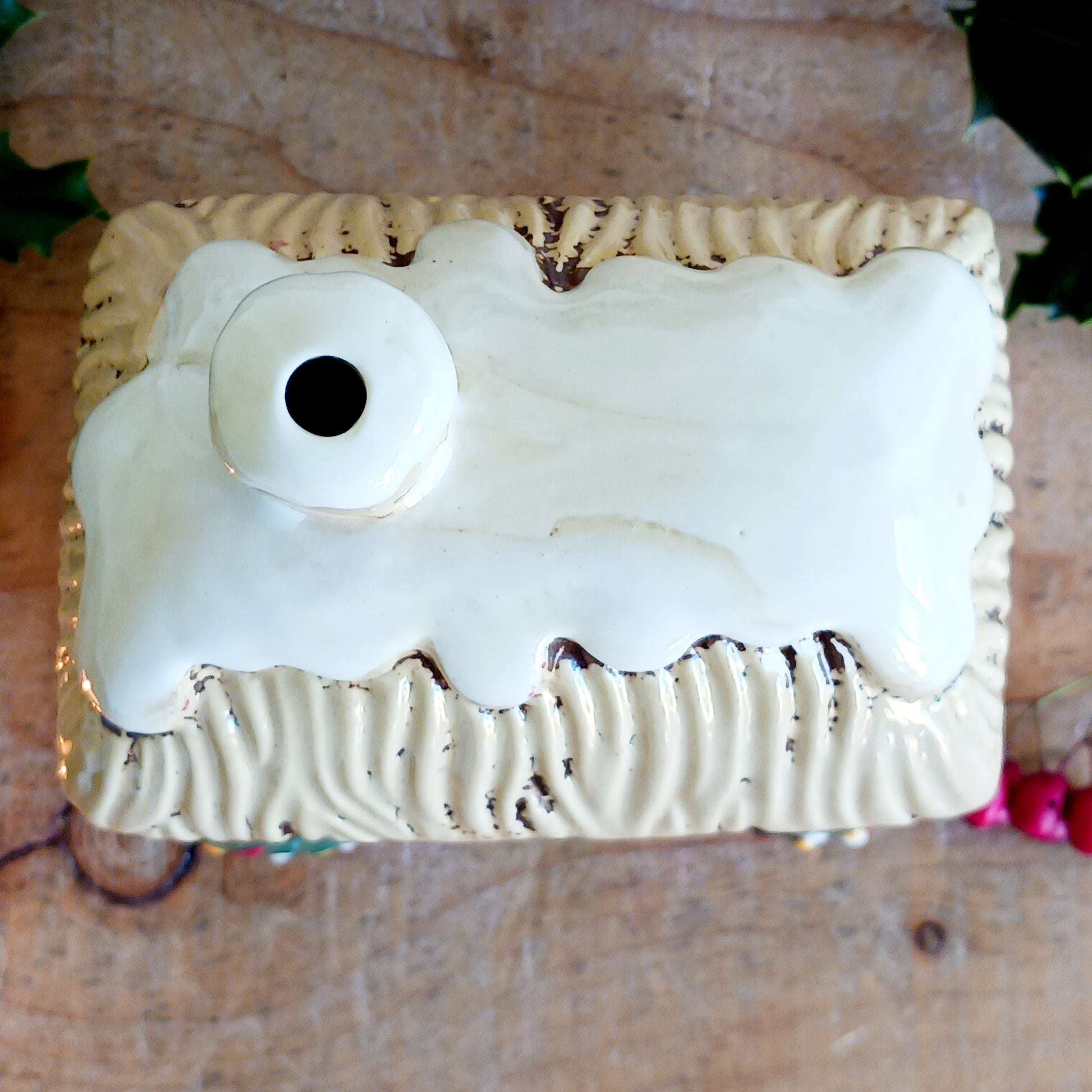 Bring timeless festive charm into your home with the Village Pottery Christmas Thatched Roof House Tealight Holder, a handcrafted ceramic cottage glowing with the spirit of the season. Measuring 17 x 12.5 x 8.5 cm, this enchanting piece captures the essence of a peaceful winter’s night — where golden candlelight flickers through snowy windows beneath a soft thatched roof.