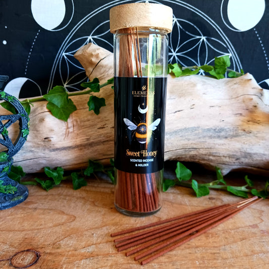 Immerse your senses in the comforting aroma of Dark Forest Sweet Honey Incense Sticks. This set includes 20 high-quality incense sticks with a soothing sweet honey fragrance, known for its calming and cozy properties. Each tube features a mystical forest bee design and comes with a reusable wooden lid that doubles as a practical incense holder. Perfect for meditation, relaxation, or simply adding a warm and inviting atmosphere to your home.
