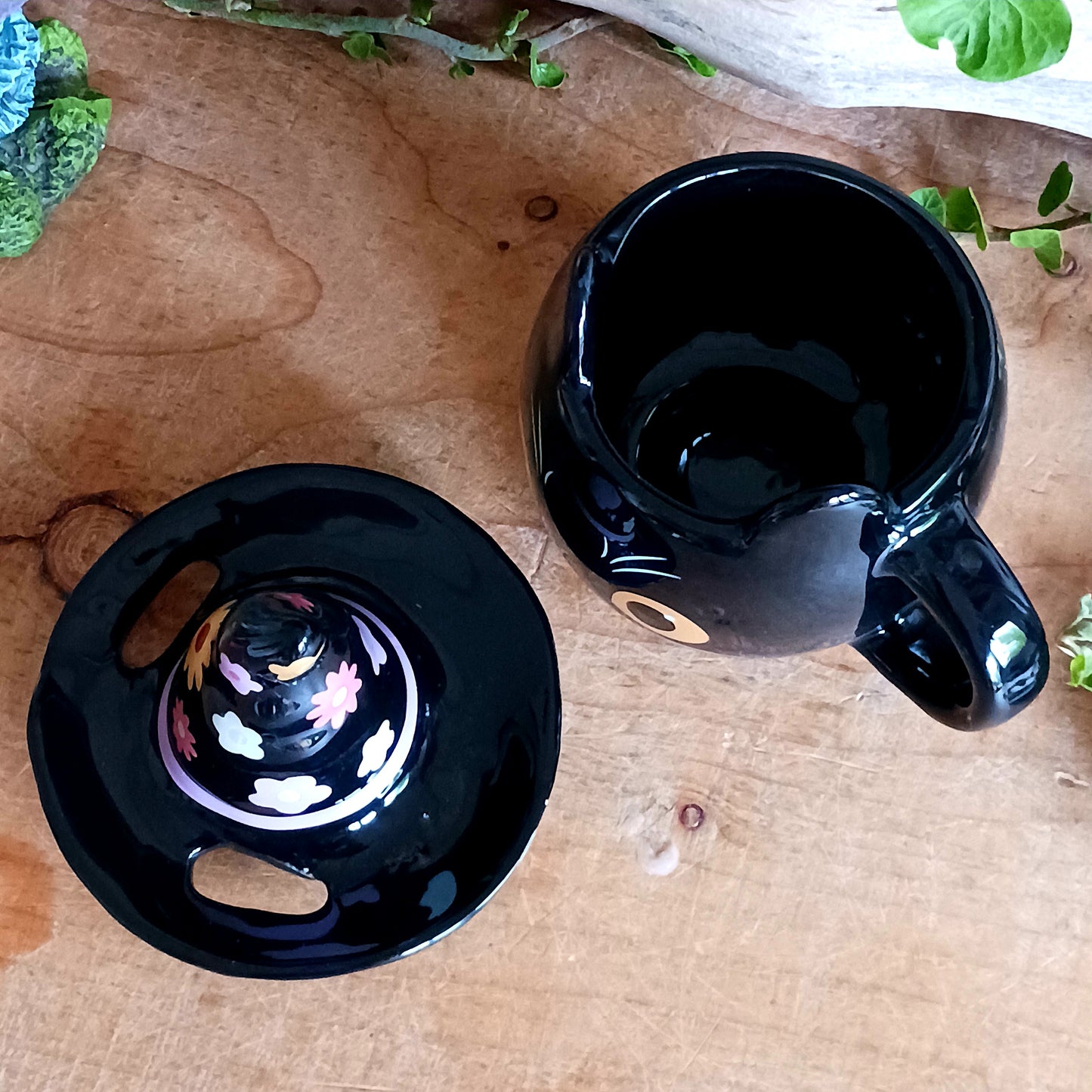 Add a spellbinding touch to your tea or coffee ritual with this groovy ceramic lidded mug, featuring an adorable cat wearing a whimsical witch hat adorned with a funky floral design. The matching ceramic lid helps keep your favourite brew warm, perfect for cosy autumn evenings or magical mornings.