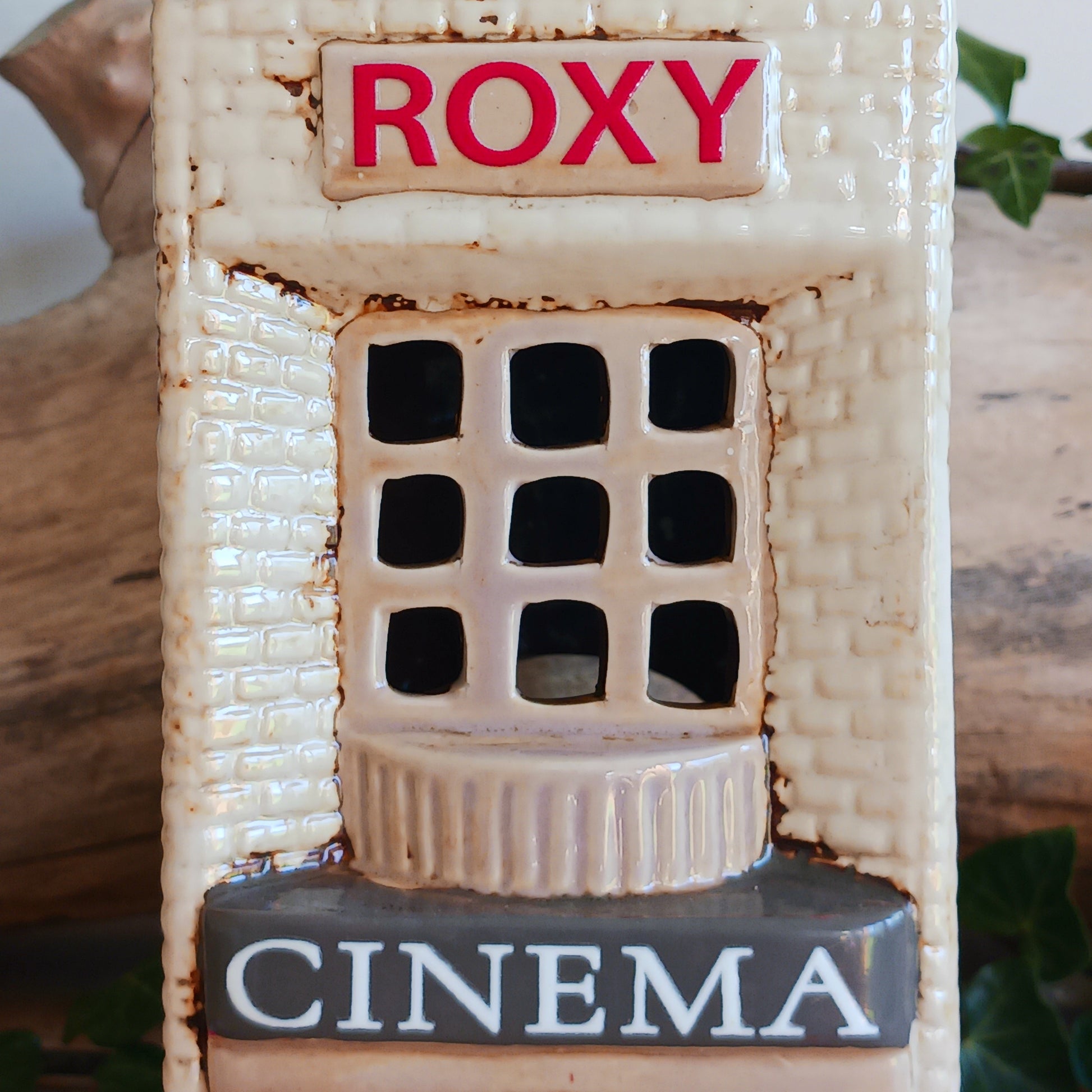 Step into a twilight screening where candlelight flickers like scenes upon an unseen reel. The Shudehill Village Pottery Roxy Cinema tealight house is crafted from ceramic, casting a soft glow through its windows to evoke a nostalgic yet enchanted village night.