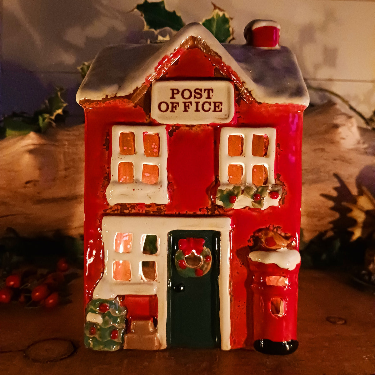 Create a cosy Christmas village scene with this charming Village Pottery Christmas Post Office Tealight Holder. Beautifully detailed as a traditional snowy village post office, it features a snow-covered roof, a post box and a delightful robin decoration for a wonderfully festive look.