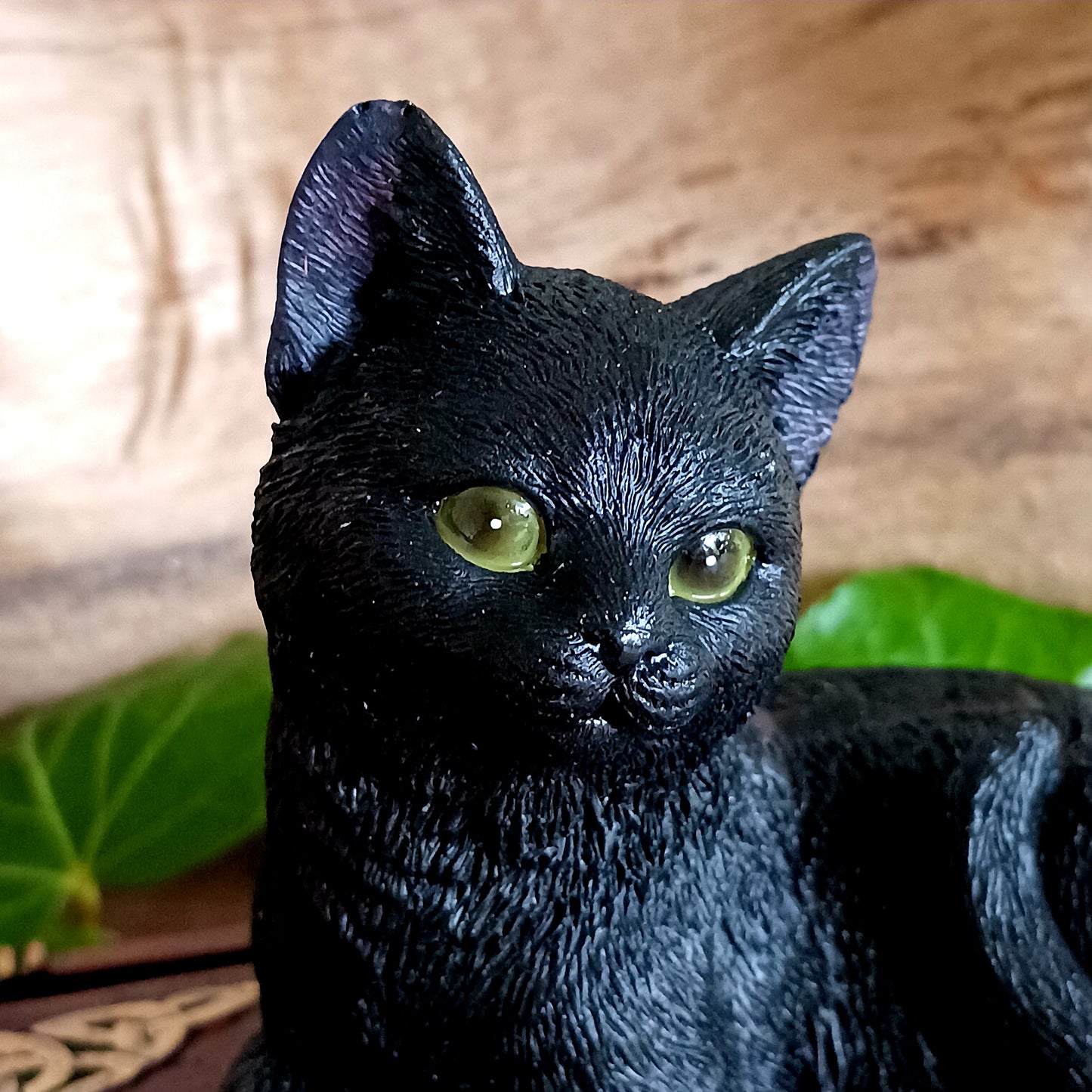 Add a touch of gothic charm to your home with this beautifully hand-painted resin figurine from Nemesis Now. Featuring a jet-black witch’s familiar perched atop two stacked spell books, this enchanting piece doubles as a storage box—simply lift the feline to reveal a hidden space perfect for trinkets, crystals, or other magical treasures. 