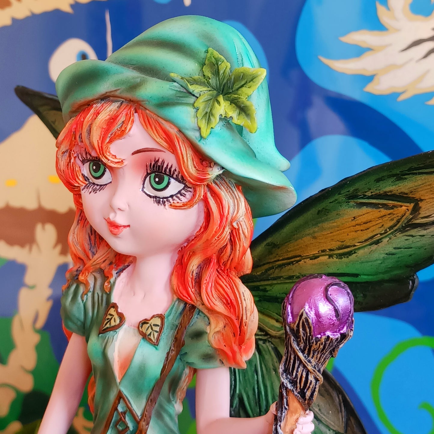 Meet Forest Fae, the whimsical guardian of the woods. This stunning standing fairy figurine captures the perfect blend of natural beauty and kawaii charm. Hand-painted with exquisite detail, she wears a lush forest green outfit, accented by leaf-shaped brooches, and holds a mystical staff crowned with a purple jewel. 