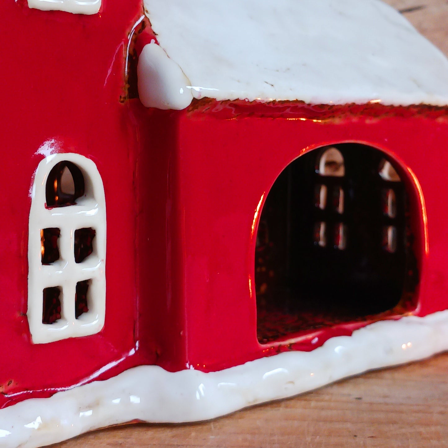 Bring festive warmth to your home with the Large Christmas Church Tealight Holder from the Village Pottery collection. This beautifully handcrafted ceramic piece features rustic detailing, evoking the charm of a snow-covered church glowing softly with candlelight.