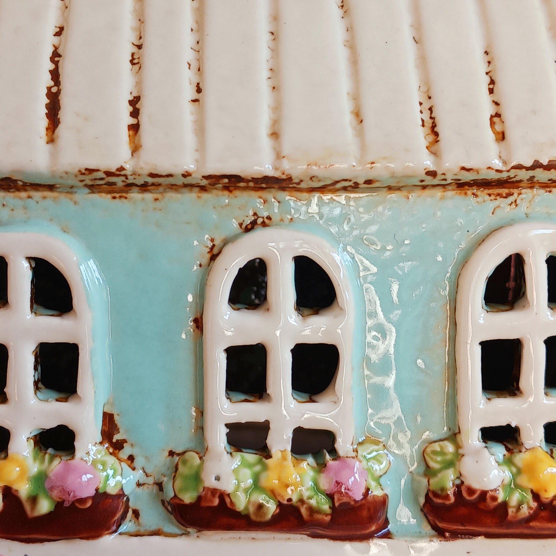 Transform your home into a warm and inviting sanctuary with the Village Pottery Gift Shop Tealight Holder. Crafted from quality ceramic, this charming piece creates a cosy, nostalgic glow when lit with a tealight. More than just a candle holder, it doubles as a delightful decorative ornament for your coffee table, shelf, or windowsill.