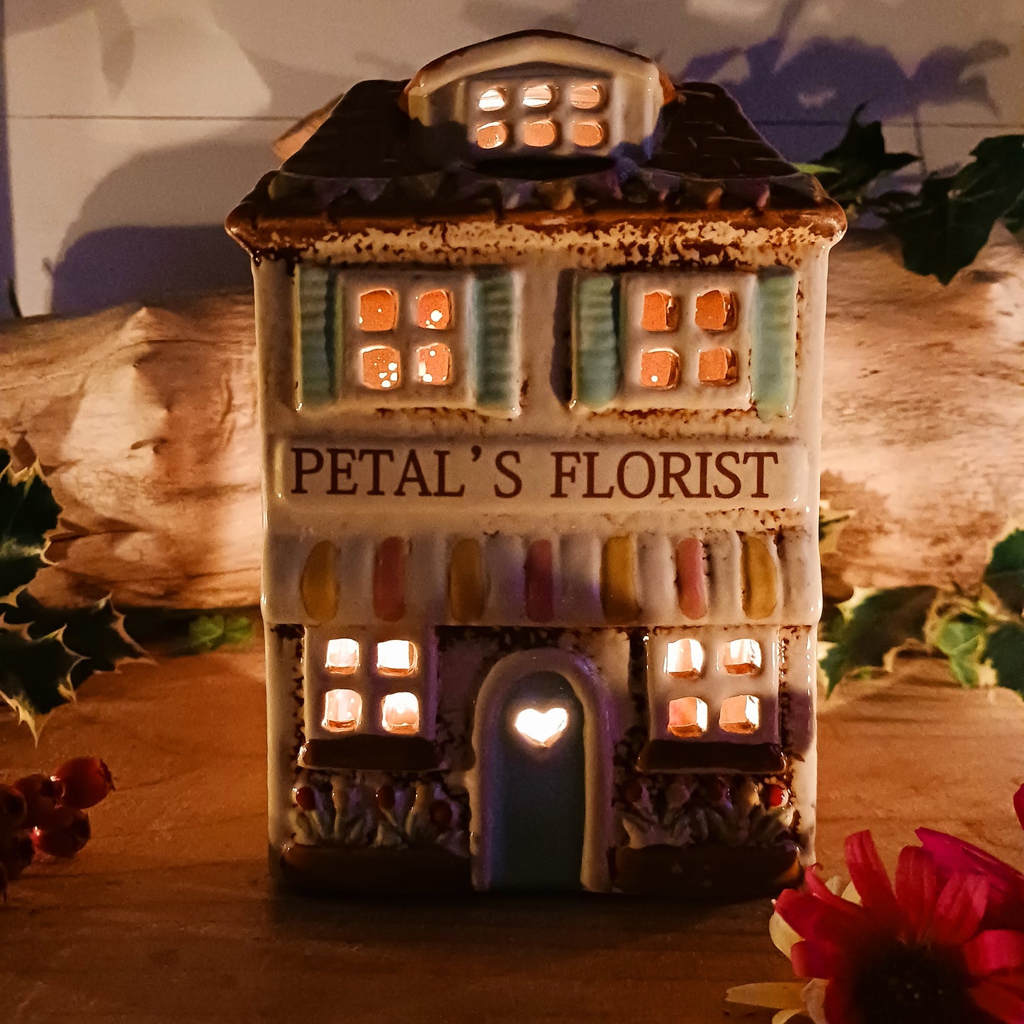 Handcrafted in the Village Pottery workshop, this Florist Tealight Holder is a true collectible from the Shudehill Collection. Made from fine ceramic with intricate detailing, it captures the nostalgic charm of a festive florist shop in a snow-dusted winter village scene.