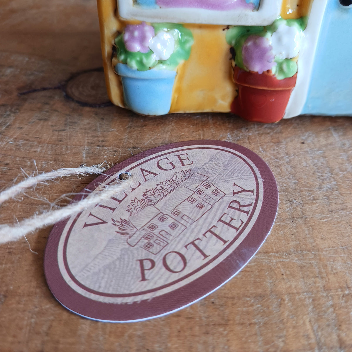 Bring a little village charm into your home with this delightful Village Pottery Boutique Tealight Holder. Hand-crafted in ceramic and beautifully hand-painted, this charming miniature shop makes a lovely decorative feature both with or without a candle.