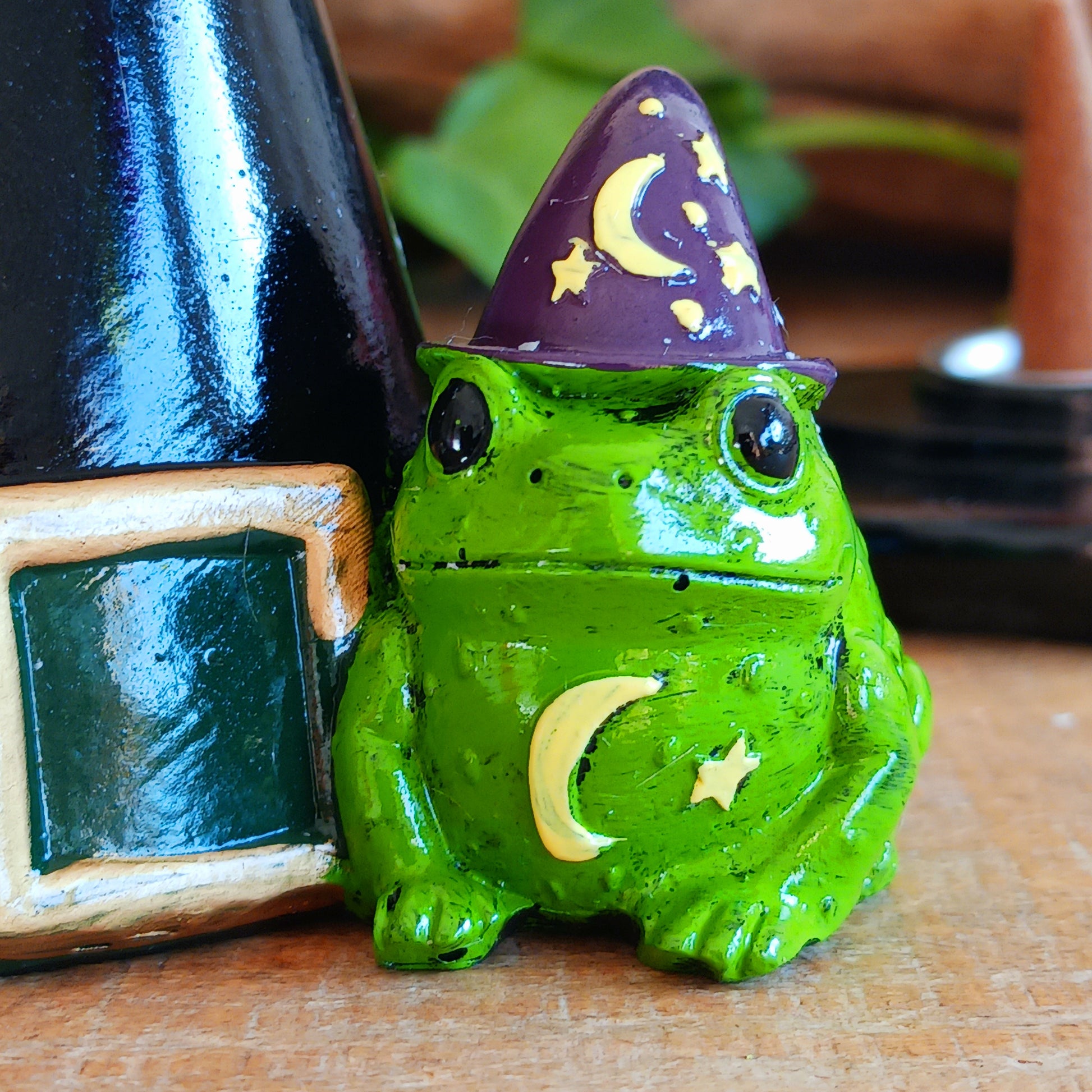 Add a touch of playful magic to your home with this charming Magic Toad & Witch Hat Incense Cone Holder. Made from resin, this quirky incense burner features a classic witch’s hat accompanied by a cute toad, creating a fun and mystical piece of witchy home décor.