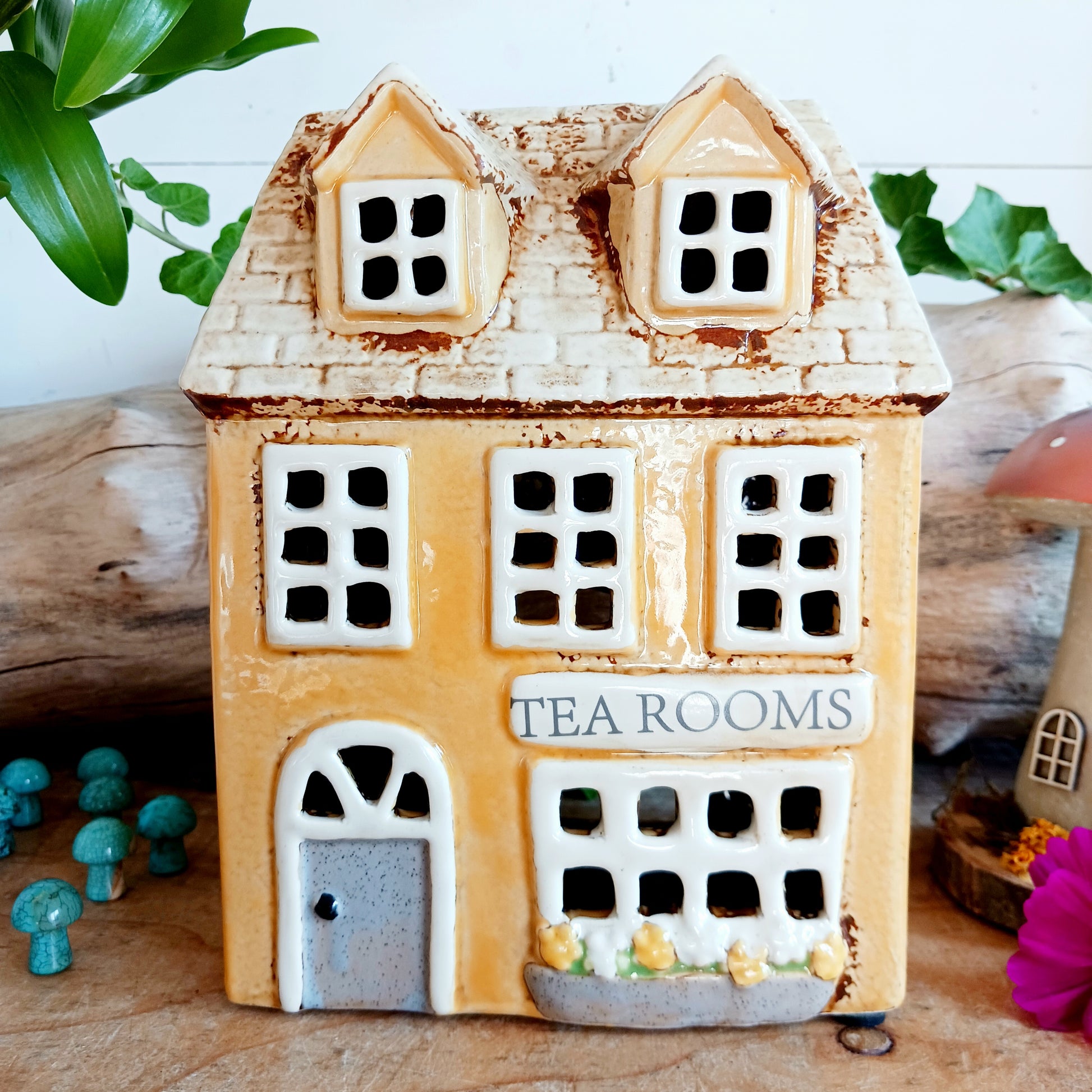 Transform your home into a warm and inviting sanctuary with the Village Pottery Tea Rooms Tealight Holder. Crafted from quality ceramic, this charming rustic piece creates a cosy, nostalgic glow when lit with a tealight. More than just a candle holder, it doubles as a delightful decorative ornament for your coffee table, shelf, or windowsill. 