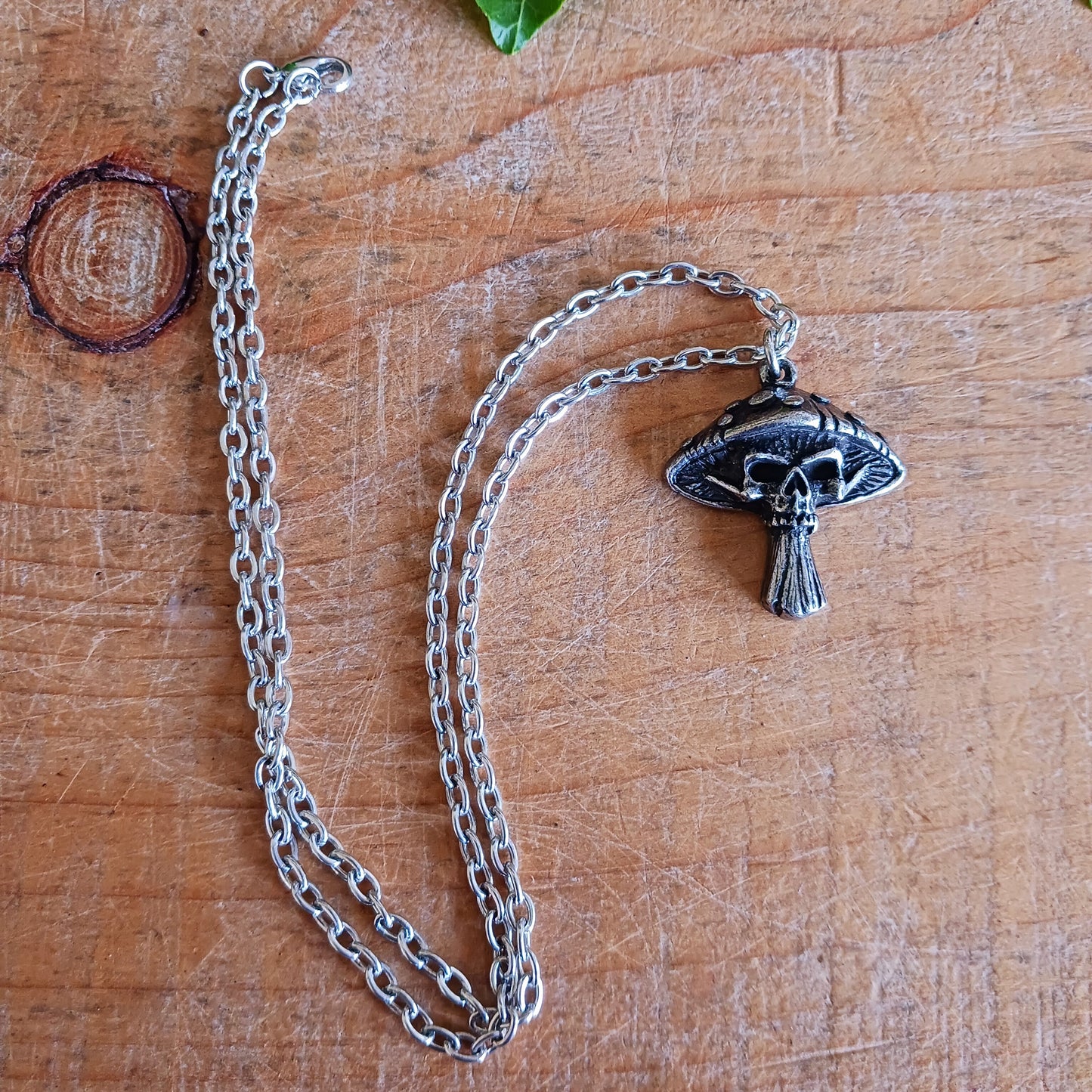 Bold, mystical, and slightly dangerous, the Death Cap Pendant draws inspiration from the legendary poisonous mushroom. Handcrafted in fine pewter, this striking pendant merges the natural form of a toadstool with a sinister skull motif, creating a statement piece that evokes folklore, witchcraft, and the darker side of nature.