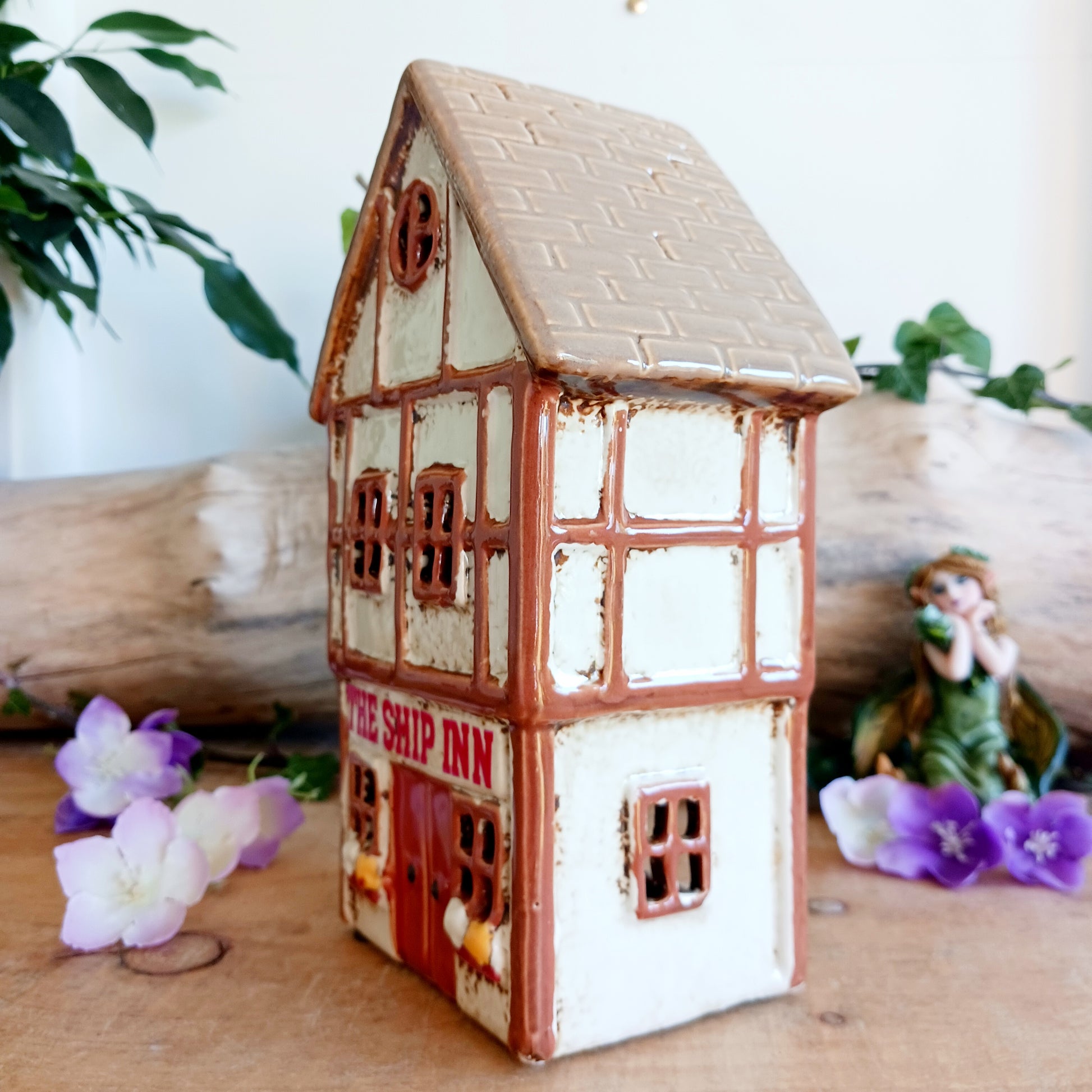 A lantern-lit refuge upon an enchanted street, the Tudor Ship Inn glows with the warmth of stories carried on twilight air. This Shudehill Village Pottery tealight house is crafted from ceramic, its windows flickering with candlelight like a haven for wandering souls.