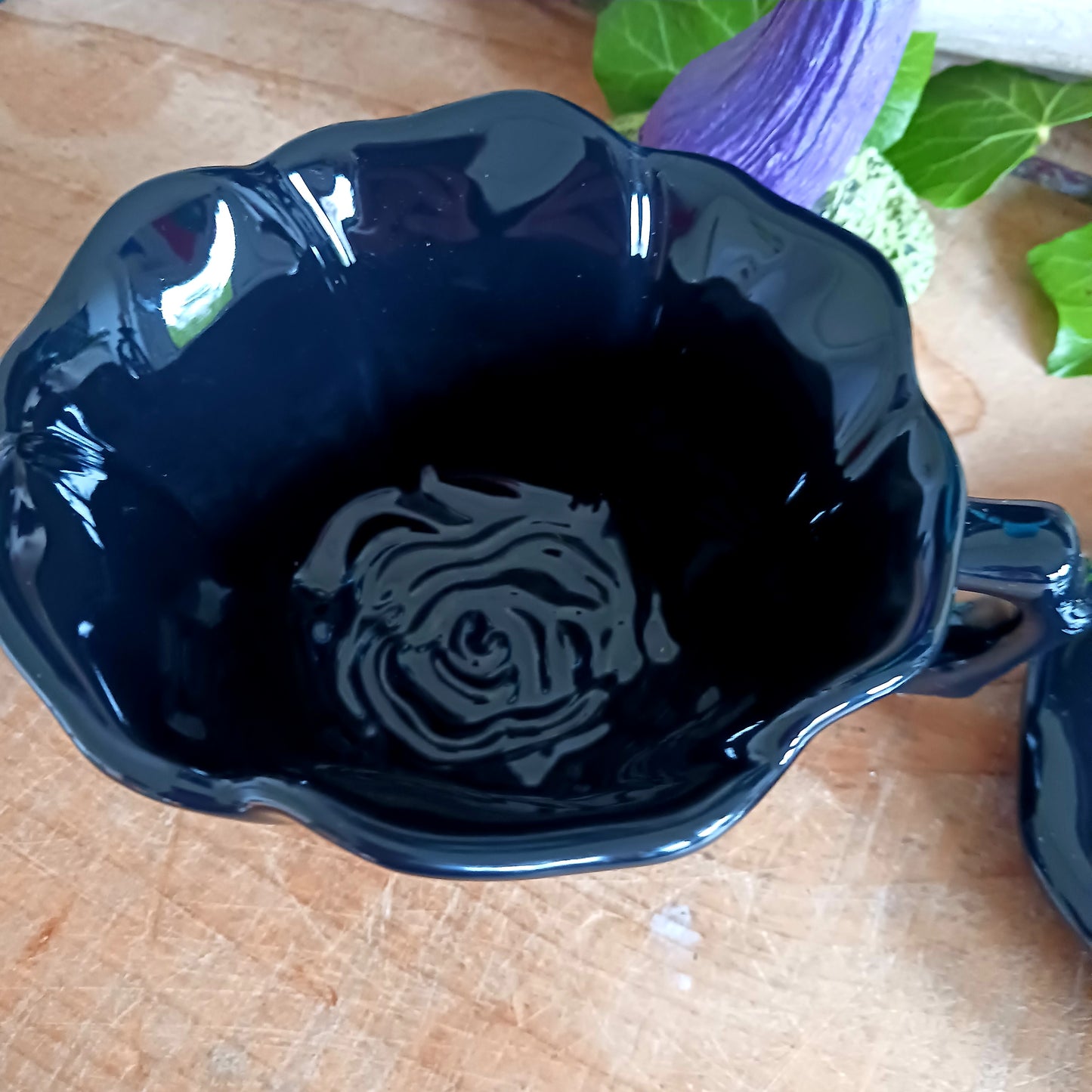 Summon timeless elegance with this black ceramic teacup and matching saucer, sculpted in the likeness of a dark, blooming rose. Designed with a dramatic silhouette and intricate petal detailing, this tea set transforms every sip into a ritual of gothic grace.