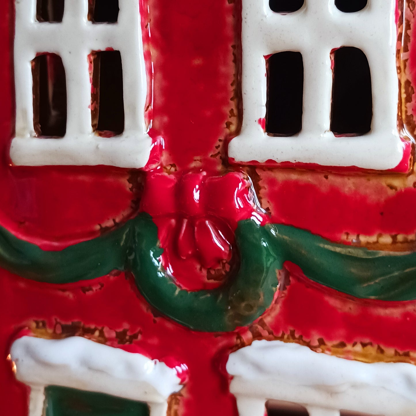 Bring the warmth and magic of Christmas into your home with this handcrafted Christmas Wreath House Tealight Holder from the Village Pottery collection. Made from high-quality ceramic and decorated with a classic wreath and rustic detailing, this piece evokes the charm of a snowy winter’s evening.