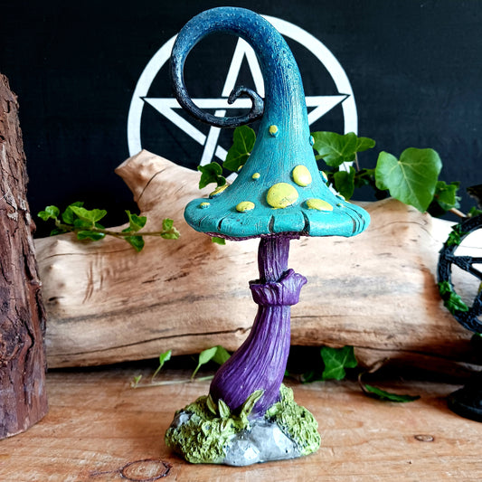 Enter the Fairy realm with this beautifully decorated Fairy-tale toadstool from alternative brand Nemesis Now. The curled, ombre cap transforms from deep indigo to sky blue and ends on a light teal colour, covered in bright yellow spots. The pale lilac stem has a striped texture that mirrors that of the common Fly Agaric Toadstool.